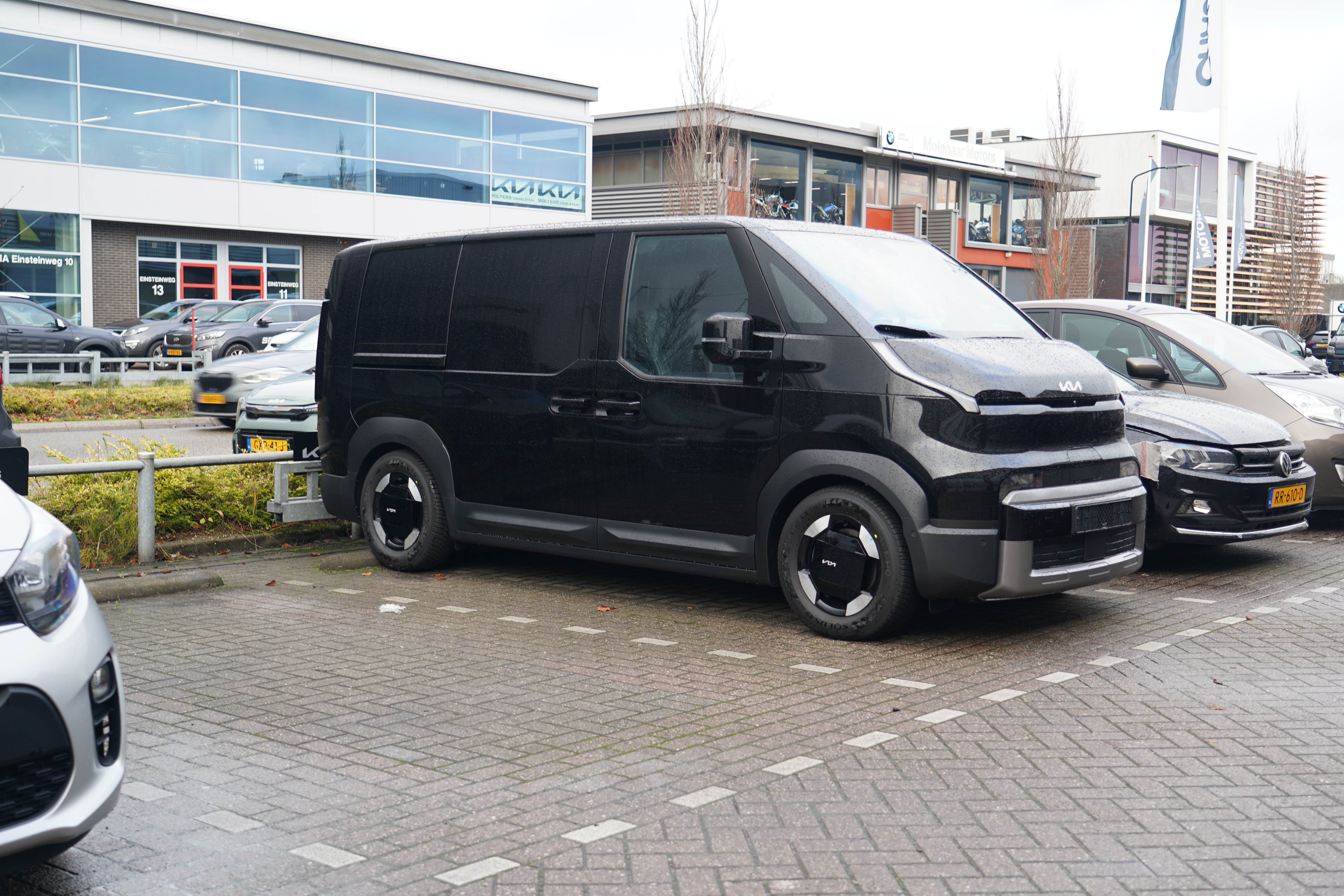 kia pv5 zwart cargo buiten parkeerplaats 